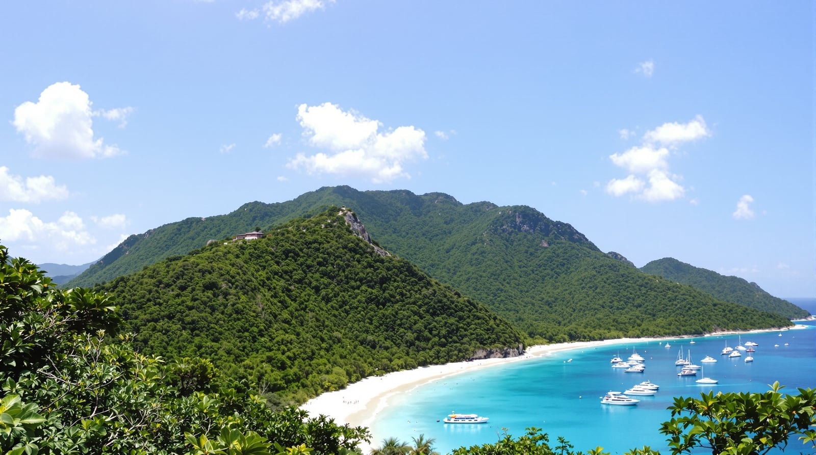A curved white sand beach with turquoise water below steep green forested hills